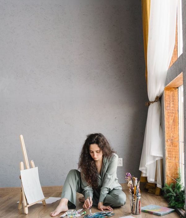 Woman feeling energized and full of vitality in a bright, clean room.